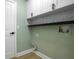 Laundry room with white cabinets, herringbone backsplash, and connections for washer and dryer at 12106 Clearbrook Ct, Riverview, FL 33569