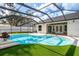 A stunning view of the custom pool inside the screened-in lanai, ideal for relaxing and entertaining at 12106 Clearbrook Ct, Riverview, FL 33569