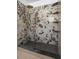 Contemporary shower with striking granite walls, black hexagon floor, and rain shower head at 12106 Clearbrook Ct, Riverview, FL 33569