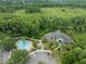 Aerial view of clubhouse and community pool surrounded by mature landscaping and beautiful scenery at 12912 Arbor Isle Dr # 202, Temple Terrace, FL 33637