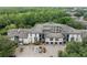 Aerial view showcasing the apartment complex surrounded by lush greenery and landscaping at 12912 Arbor Isle Dr # 202, Temple Terrace, FL 33637
