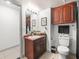 Bathroom with wood cabinets, dark shower curtain, black towels, and decor at 12912 Arbor Isle Dr # 202, Temple Terrace, FL 33637