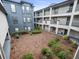 Exterior view of condo buildings overlooking courtyard with well maintained landscaping at 12912 Arbor Isle Dr # 202, Temple Terrace, FL 33637