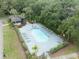 Aerial view of fenced community pool with several lounge chairs and mature landscaping at 12912 Arbor Isle Dr # 202, Temple Terrace, FL 33637