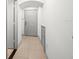 Hallway with white walls and a white door on tile flooring at 12912 Arbor Isle Dr # 202, Temple Terrace, FL 33637