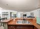 This kitchen features granite counters, stainless steel appliances, and an island with breakfast bar at 12912 Arbor Isle Dr # 202, Temple Terrace, FL 33637