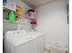 Laundry room with washer, dryer, shelving, and storage baskets at 12912 Arbor Isle Dr # 202, Temple Terrace, FL 33637