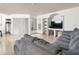 Bright living room with tile flooring, built-in shelving, a comfortable sectional sofa, and natural light at 12912 Arbor Isle Dr # 202, Temple Terrace, FL 33637