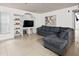 Inviting living room with tile flooring, built-in shelving, and a comfortable sectional sofa at 12912 Arbor Isle Dr # 202, Temple Terrace, FL 33637