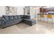Open concept living area featuring a sectional sofa, kitchen, and dining area at 12912 Arbor Isle Dr # 202, Temple Terrace, FL 33637