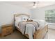 Bright main bedroom features a tray with decor on the bed, a ceiling fan, and lots of natural light at 12912 Arbor Isle Dr # 202, Temple Terrace, FL 33637