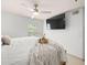Bright main bedroom with ceiling fan, mounted tv, and lots of natural light from the window at 12912 Arbor Isle Dr # 202, Temple Terrace, FL 33637