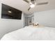 Bright main bedroom with ceiling fan, mounted tv, and walk in closet, features clean decor at 12912 Arbor Isle Dr # 202, Temple Terrace, FL 33637