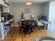 Open dining area with modern black table and chairs and hardwood floors at 1301 S Howard Ave # C4, Tampa, FL 33606