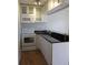Efficient kitchen with white cabinets, modern appliances, and dark countertops at 1301 S Howard Ave # C4, Tampa, FL 33606