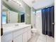 Bathroom with a long vanity, white cabinets, tub and shower combo, and neutral tones at 1319 Dew Bloom Rd, Valrico, FL 33594