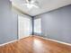 Bedroom features a ceiling fan, closet with double doors, and natural light at 1319 Dew Bloom Rd, Valrico, FL 33594