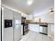 Well-equipped kitchen with stainless steel appliances, white cabinets, and breakfast bar overlooking the living area at 1319 Dew Bloom Rd, Valrico, FL 33594