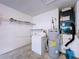 Functional laundry room with washer, shelving, and water heater for added convenience at 1319 Dew Bloom Rd, Valrico, FL 33594