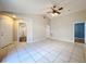 Bright living room boasts tile flooring, ceiling fan, and neutral walls, creating an inviting atmosphere at 1319 Dew Bloom Rd, Valrico, FL 33594
