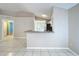 Bright living area leading to the kitchen, featuring tile floors and ample natural light at 1319 Dew Bloom Rd, Valrico, FL 33594