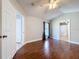 Spacious main bedroom with hardwood floors, a ceiling fan, and an ensuite bathroom at 1319 Dew Bloom Rd, Valrico, FL 33594