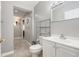 Neutral bathroom featuring gray walls, tiled floors, and a chrome storage shelf at 1533 Suffolk N St, St Petersburg, FL 33710