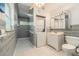 Bathroom with a tiled shower, stackable washer and dryer unit, and modern vanity at 1533 Suffolk N St, St Petersburg, FL 33710