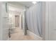 Bathroom with shower-tub combo, tiled floor, toilet, vanity, and open doorway at 1533 Suffolk N St, St Petersburg, FL 33710