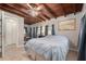 Bedroom with a wooden ceiling, tile flooring, natural light, and a comfortable bed at 1533 Suffolk N St, St Petersburg, FL 33710