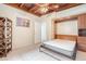 Bedroom with wood ceiling, tile floor, murphy bed, closet, window, and open dark wood bookcase at 1533 Suffolk N St, St Petersburg, FL 33710