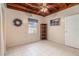 Bedroom featuring a wood ceiling, tile floor, closet, window, wreath, bookcase, and colorful painting at 1533 Suffolk N St, St Petersburg, FL 33710