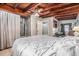 Bedroom featuring a wooden ceiling, tile floors, an open bathroom, and natural light at 1533 Suffolk N St, St Petersburg, FL 33710