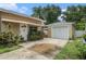 Charming home exterior highlighting a detached garage and landscaping at 1533 Suffolk N St, St Petersburg, FL 33710