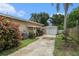 View of home showing driveway leading to detached garage and view of front entrance at 1533 Suffolk N St, St Petersburg, FL 33710