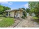 Attractive single-story home with a covered front porch and a well-manicured lawn at 1533 Suffolk N St, St Petersburg, FL 33710