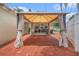 Backyard with brick-paved area featuring a curtained gazebo and view of a covered patio at 1533 Suffolk N St, St Petersburg, FL 33710
