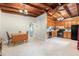Open kitchen and dining area features wood ceiling, tile flooring, and black appliances at 1533 Suffolk N St, St Petersburg, FL 33710
