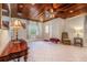 Stylish living area with a dark wood ceiling, tile flooring, and ample natural light at 1533 Suffolk N St, St Petersburg, FL 33710