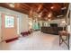 Bright living room with tile flooring, wood ceilings, and a decorative front door with sidelights at 1533 Suffolk N St, St Petersburg, FL 33710