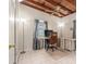Well-lit home office with tile flooring, work desk, and a comfortable leather office chair at 1533 Suffolk N St, St Petersburg, FL 33710