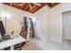 Well-lit home office featuring tile floors, a white desk and a comfortable leather office chair at 1533 Suffolk N St, St Petersburg, FL 33710