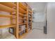 Large walk-in closet with wood and wire shelving, drawers, and tile floor at 1533 Suffolk N St, St Petersburg, FL 33710