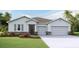 Inviting single-story home with a two-car garage, stone accents, and a well-manicured lawn at 19669 Gladeview Way, Land O Lakes, FL 34638