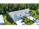 An aerial view showcases the home with its well-maintained roof, landscaping, and expansive driveway at 2019 Gardenia Landings Lane Ln, Sun City Center, FL 33573