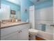 Well-lit bathroom boasts a single sink, granite countertop, and a shower-tub combo at 2019 Gardenia Landings Lane Ln, Sun City Center, FL 33573