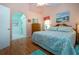 Bedroom with attached bathroom, hardwood floors, and soft decor at 2019 Gardenia Landings Lane Ln, Sun City Center, FL 33573
