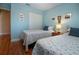 This bedroom features two twin beds, hardwood flooring, and a closet at 2019 Gardenia Landings Lane Ln, Sun City Center, FL 33573