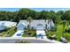 A picturesque home with a well-manicured lawn, palm trees, and a spacious two-car garage at 2019 Gardenia Landings Lane Ln, Sun City Center, FL 33573