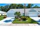 Charming single-story home featuring a two-car garage, lush landscaping, and a well-manicured lawn at 2019 Gardenia Landings Lane Ln, Sun City Center, FL 33573